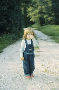 Full length of a girl walking on road