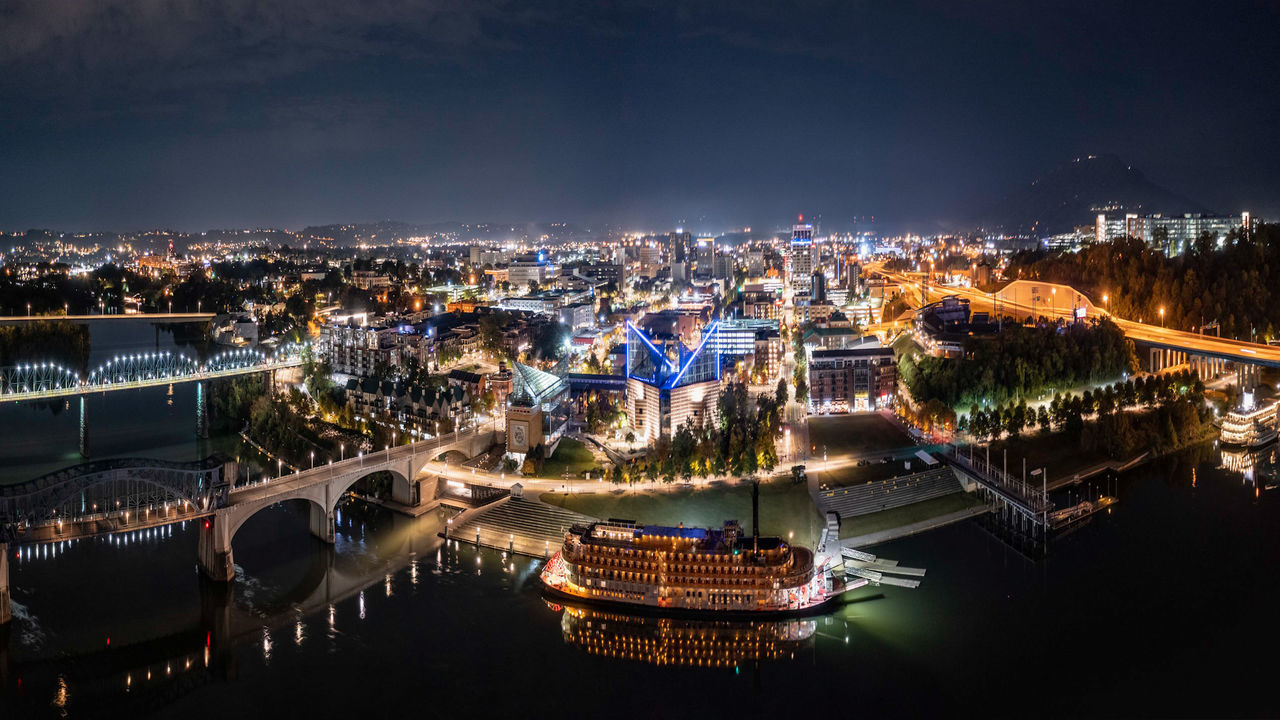 HIGH ANGLE VIEW OF ILLUMINATED CITY BUILDINGS AGAINST SKY