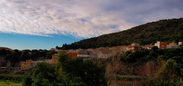 Buildings in town against sky