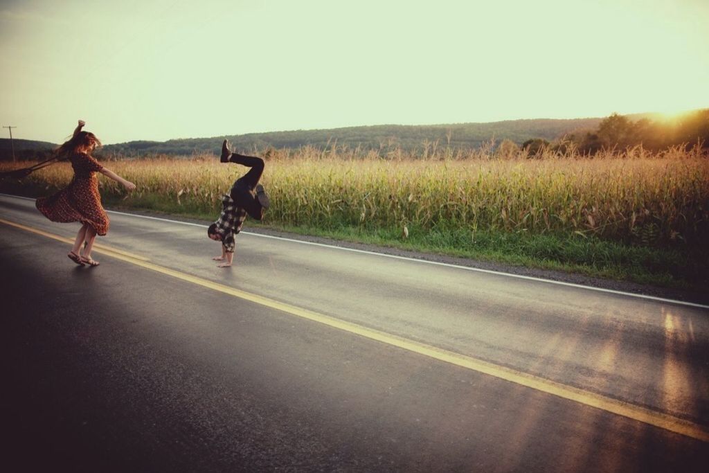 lifestyles, transportation, bicycle, full length, road, leisure activity, men, riding, clear sky, field, grass, land vehicle, landscape, walking, street, rear view, cycling, sunlight