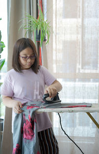 Girl doing laundry at home