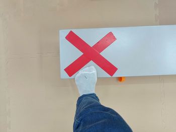 Low section of man standing by text on wall