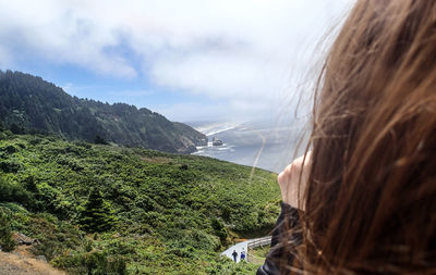 Cropped image of woman with mountains in background