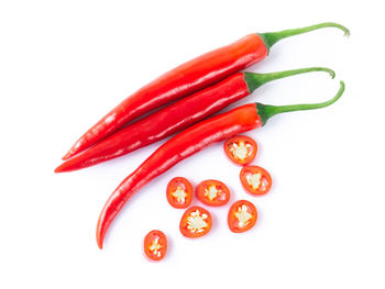 Close-up of red chili pepper against white background