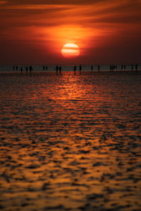 Scenic view of sea against orange sky