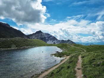 Scenic view of mountains against cloudy sky