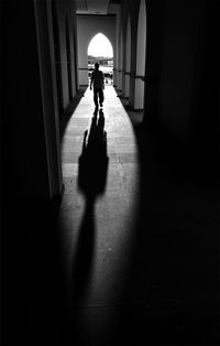 Full length of woman walking in tunnel