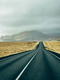 Empty road against sky