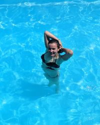 High angle view of woman swimming in pool