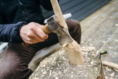 Midsection of man working on wood