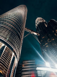 Low angle view of illuminated buildings against sky at night