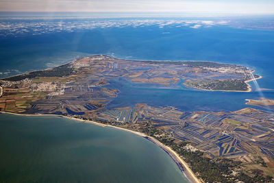 Aerial view of sea and mountains against sky