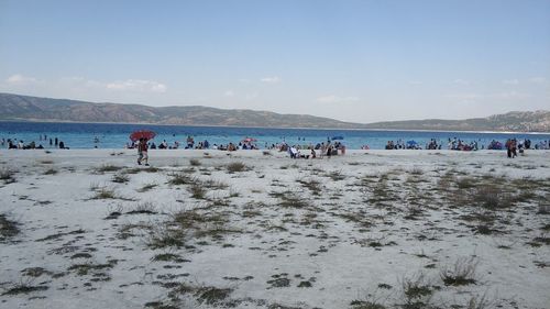 People on beach against sky