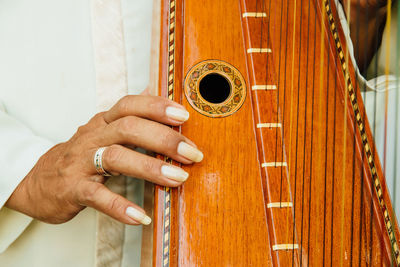 Close-up of woman playing harp