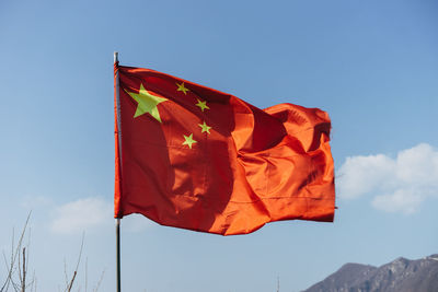 Low angle view of chinese flag against sky