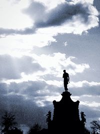 Statue against cloudy sky