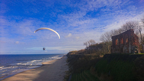 Scenic view of flying person over the sea