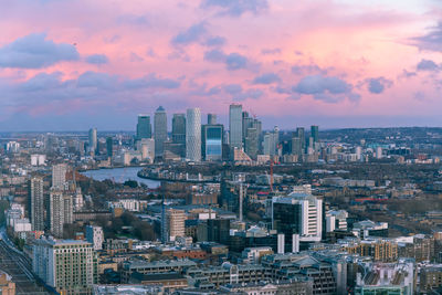 Aerial view of buildings in city against sky during sunset