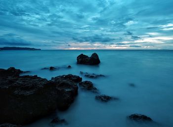 Scenic view of sea against cloudy sky