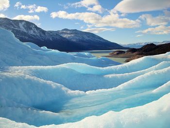 Scenic view of snow covered mountains against sky