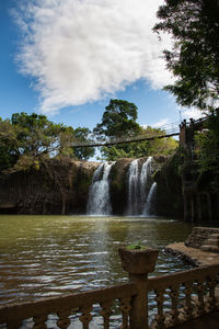 Scenic view of waterfall against sky