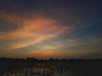 Scenic view of agricultural field against sky during sunset