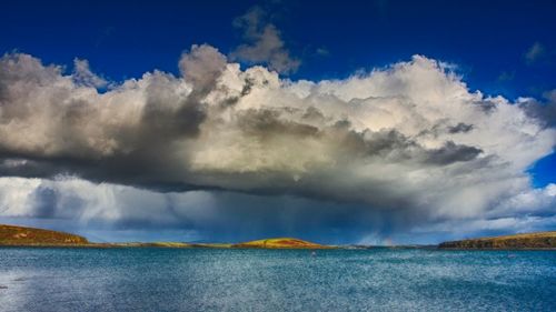 Panoramic view of sea against cloudy sky