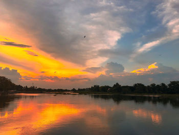 Scenic view of lake against sky at sunset