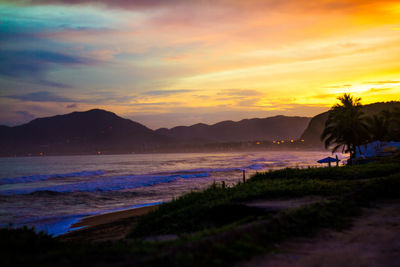 Scenic view of beach against sky during sunset