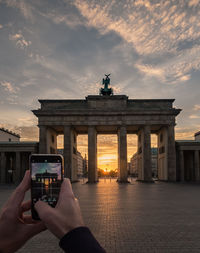 Man photographing at sunset