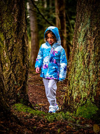 Portrait of woman standing in forest
