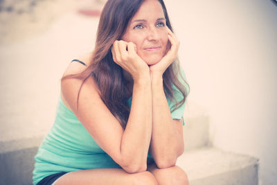 Close-up of smiling woman sitting outdoors