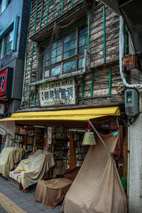 Clothes hanging on street by buildings in city