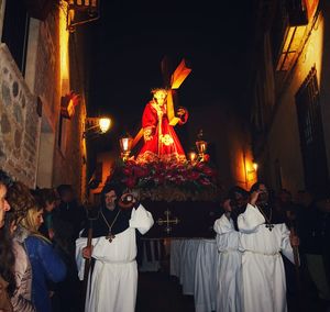 Group of people in front of illuminated building at night