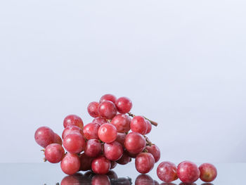 Close-up of red cherries against white background