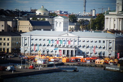 Boats in canal by buildings in city