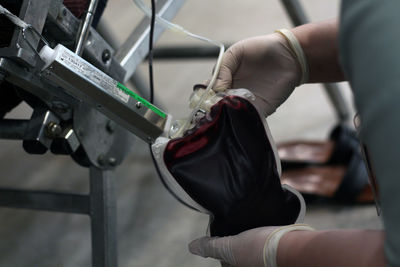 Close-up of healthcare working holding blood in transparent bag