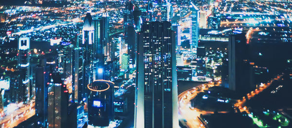 High angle view of illuminated buildings in city at night