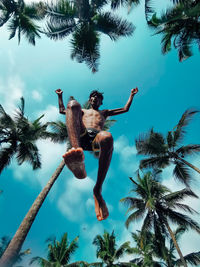 Low angle view of coconut palm tree against sky