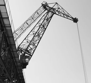 Low angle view of crane against clear sky