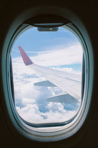 Aerial view of clouds seen through airplane window