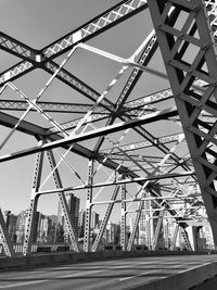 Low angle view of bridge against sky in city