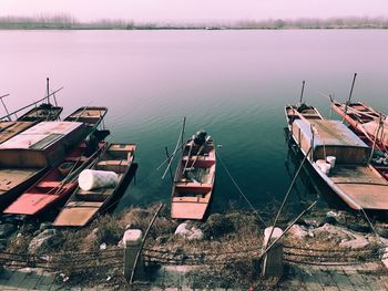 High angle view of boats moored in lake against sky