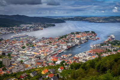 High angle view of city by sea against sky