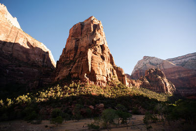 Rock formations on landscape against clear sky