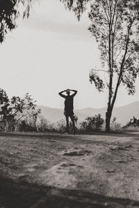 Rear view of man walking on field