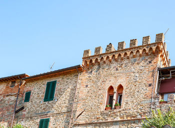 Low angle view of old building against clear blue sky