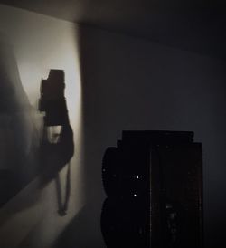 Reflection of silhouette camera on wall