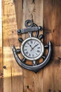 Close-up of old clock on wooden wall