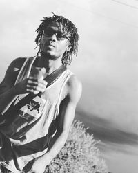 Portrait of woman standing against sky